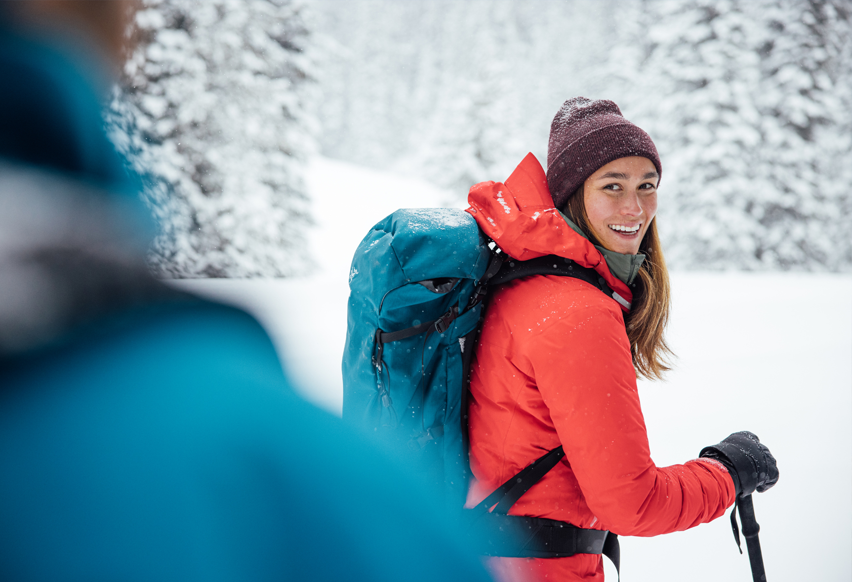 Woman smiling while on a snowy trail