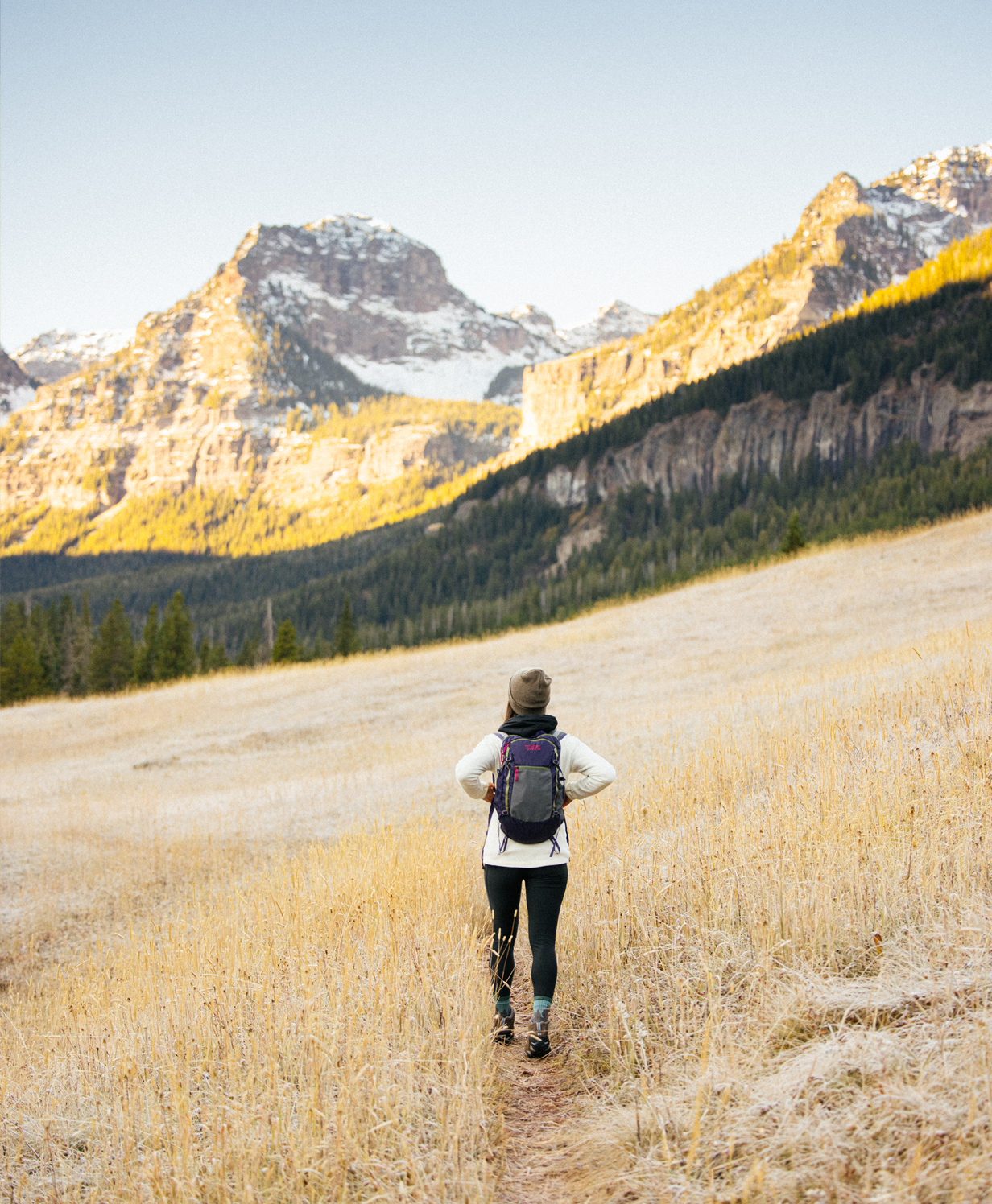 Woman hiking through a mountain meadow in the Oboz Sawtooth hiking boot.
