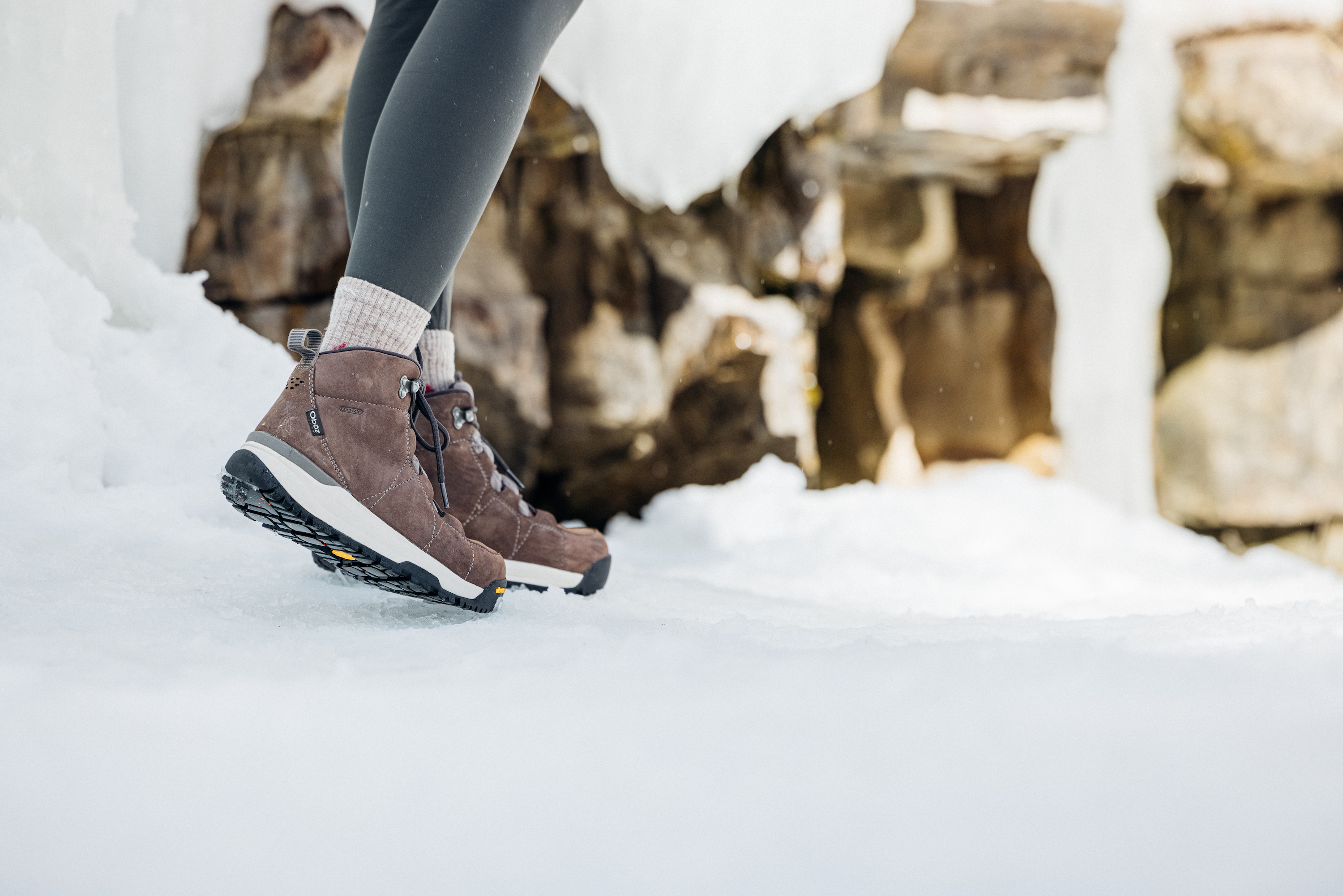 The Oboz  Women's Sphinx Mid Insulated boot on an icy winter trail.