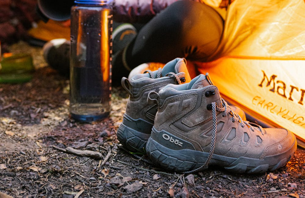 Womens Sawtooth X Mid hiking boots by the tent.