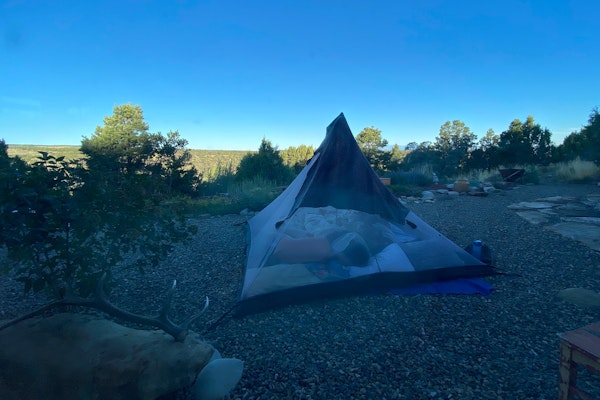 A tent set up in the wilderness