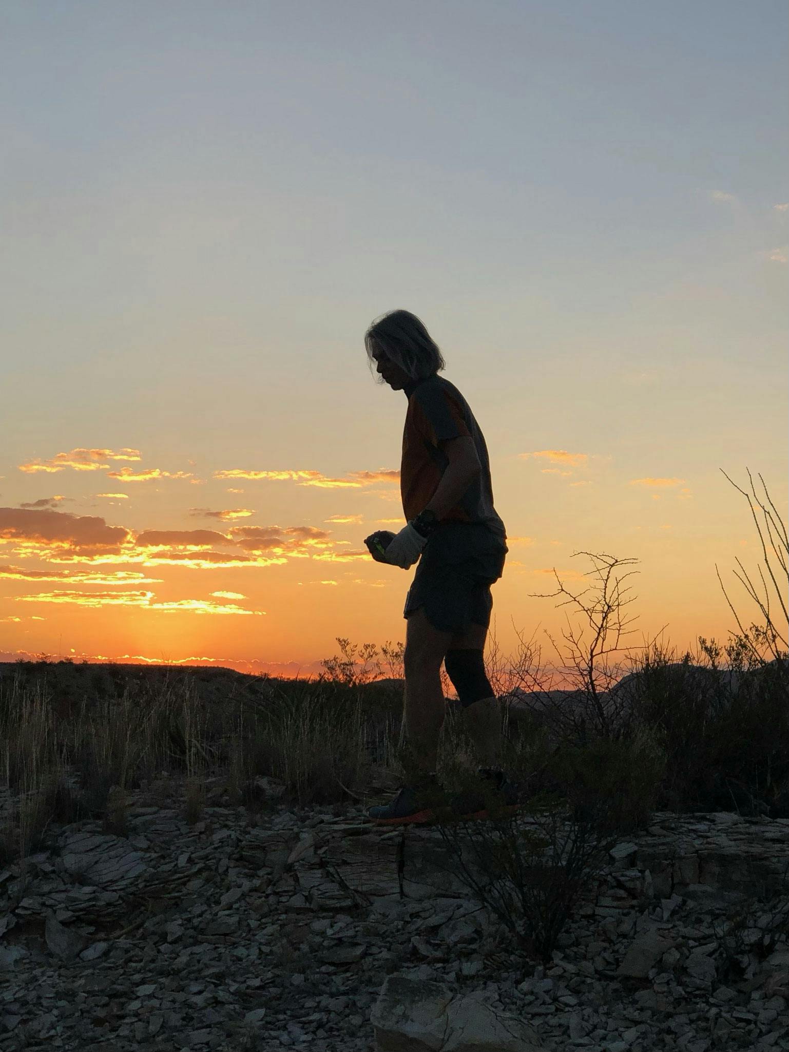 Oboz Trailblazer Buddy Teaster hiking at sunset in Oboz hiking shoes