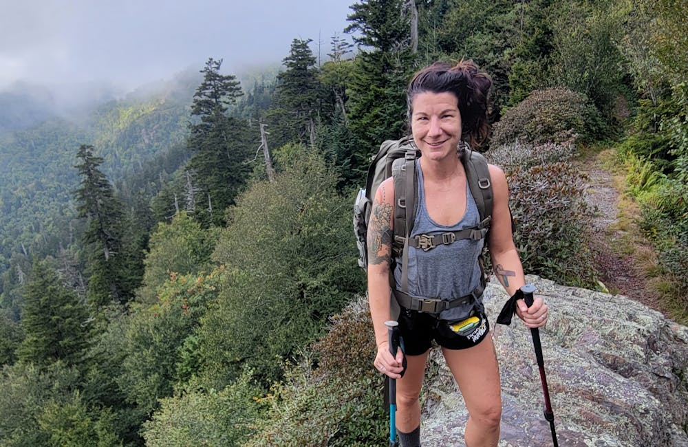 Oboz Footwear Lindsay Hill smiling while on a hike in the forest.