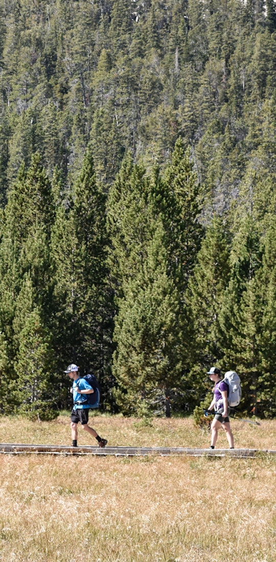 Two hikers on a boardwalk in the Oboz Arete hiking shoes.