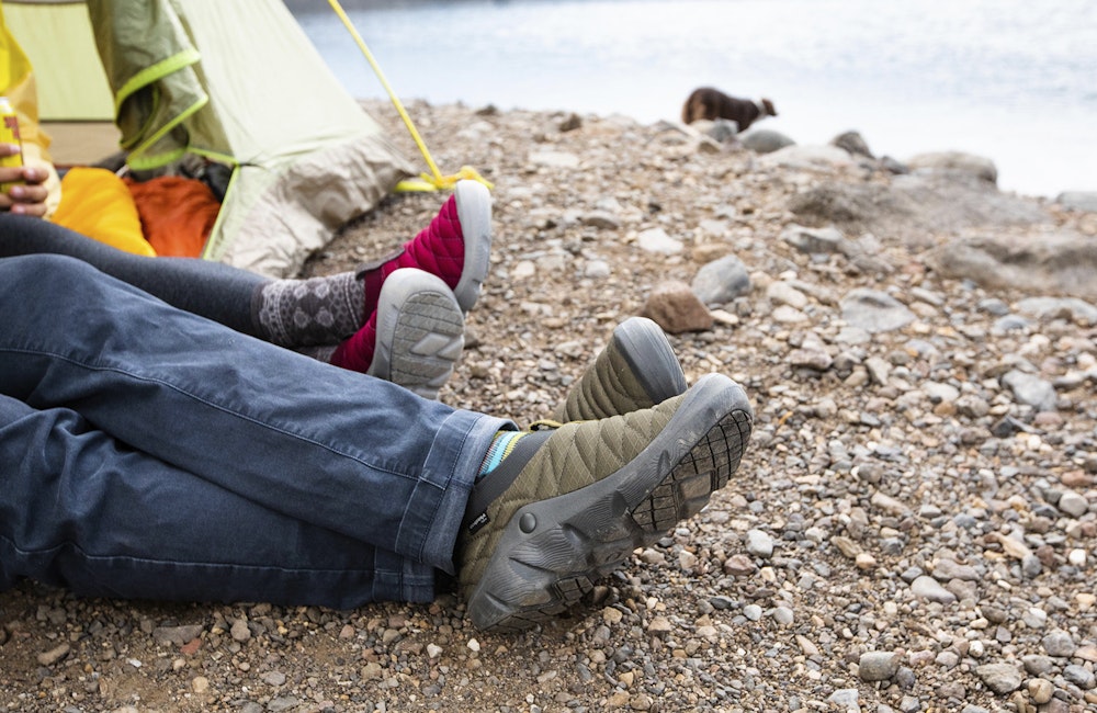 Two people in a tent at Hyalite lake wearing Oboz Whakata Puffy slippers.