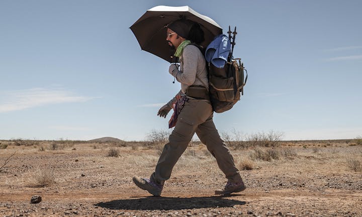 Person hiking is the Oboz Sawtooth X Mid in the desert.