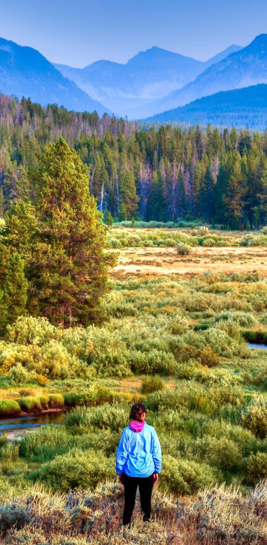A hiker wearing Oboz hiking boots enjoying a gorgeous Montana landscape.