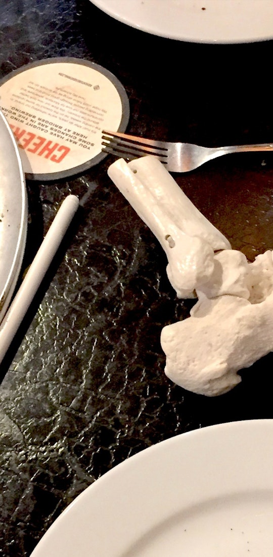 Human foot skeleton model and pizza staged for an informative Oboz article.