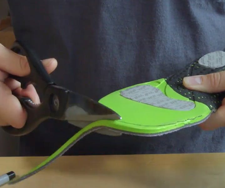 Trimming a pair of Oboz replacement insoles.