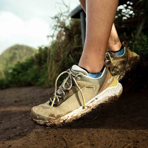 Woman wearing Oboz Cottonwood Low Waterproof hiking shoes on a sunny day.