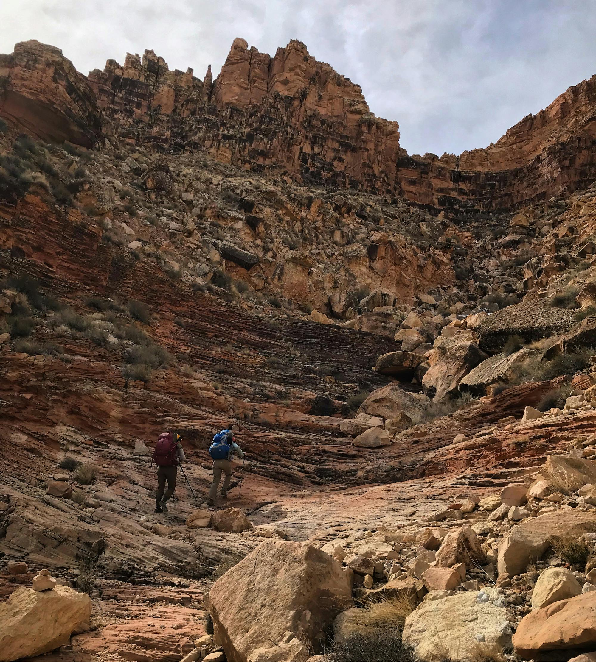 Two hikers hiking up to the rim of the Grand Canyon in Oboz hiking boots.