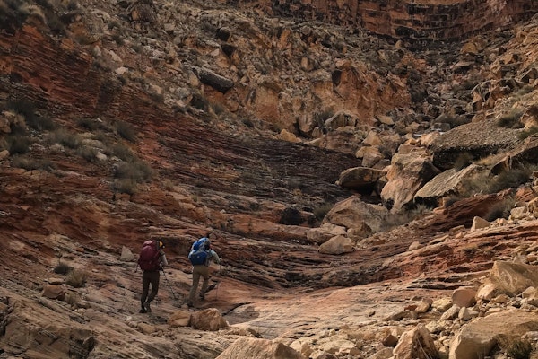 Two hikers hiking up to the rim of the Grand Canyon in Oboz hiking boots.