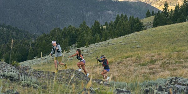 Group of hikers trail running up a mountain in Montana wearing Oboz trail shoes.