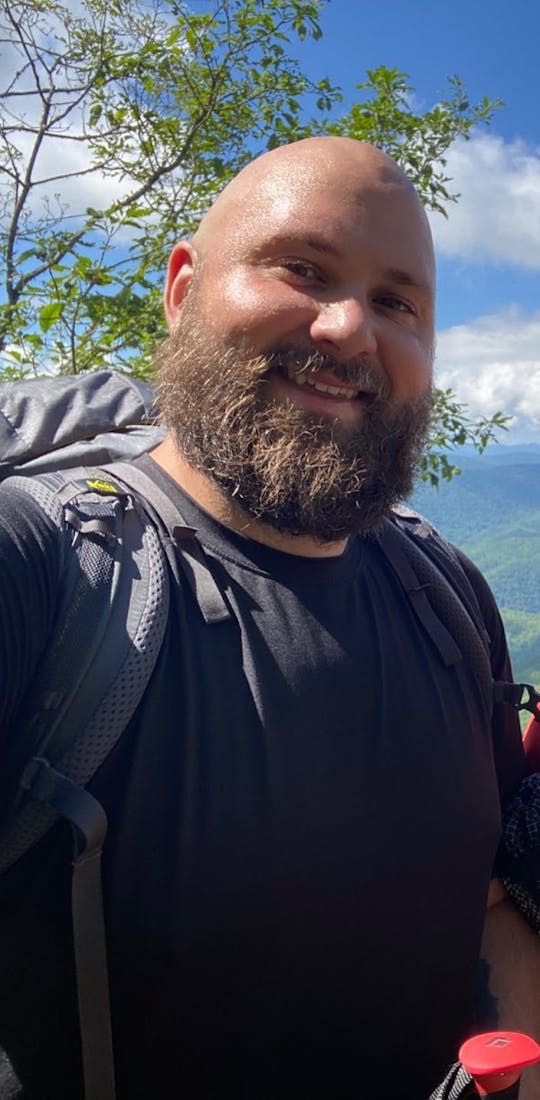 Two individuals backpacking the Smokies on a bright and sunny day