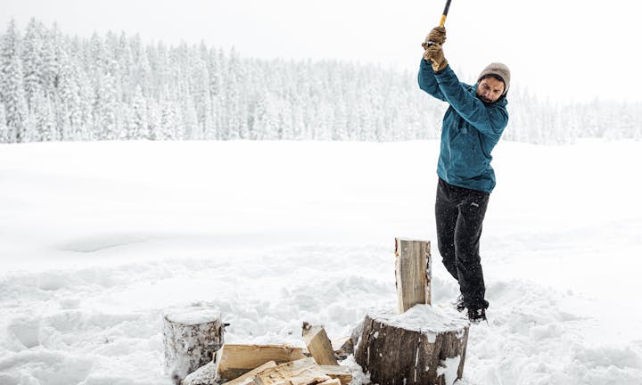 Chopping wood in cold winter conditions wear Oboz winter boots.