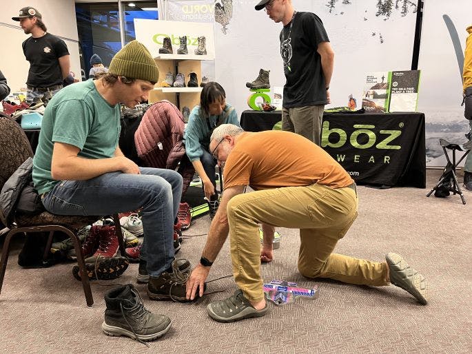 Person being fit for an Oboz hiking boot at the Banff film festival. 