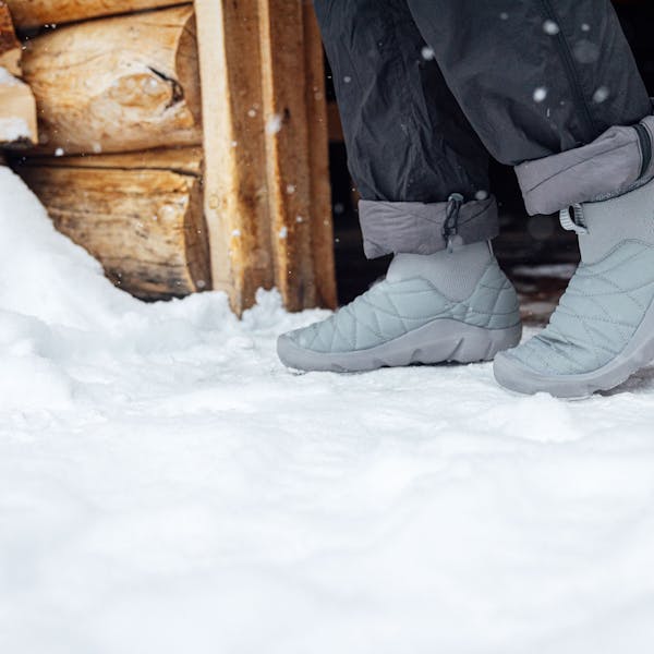 Wearing Oboz Whakatā Puffy Mid slipper shoes in the snow.