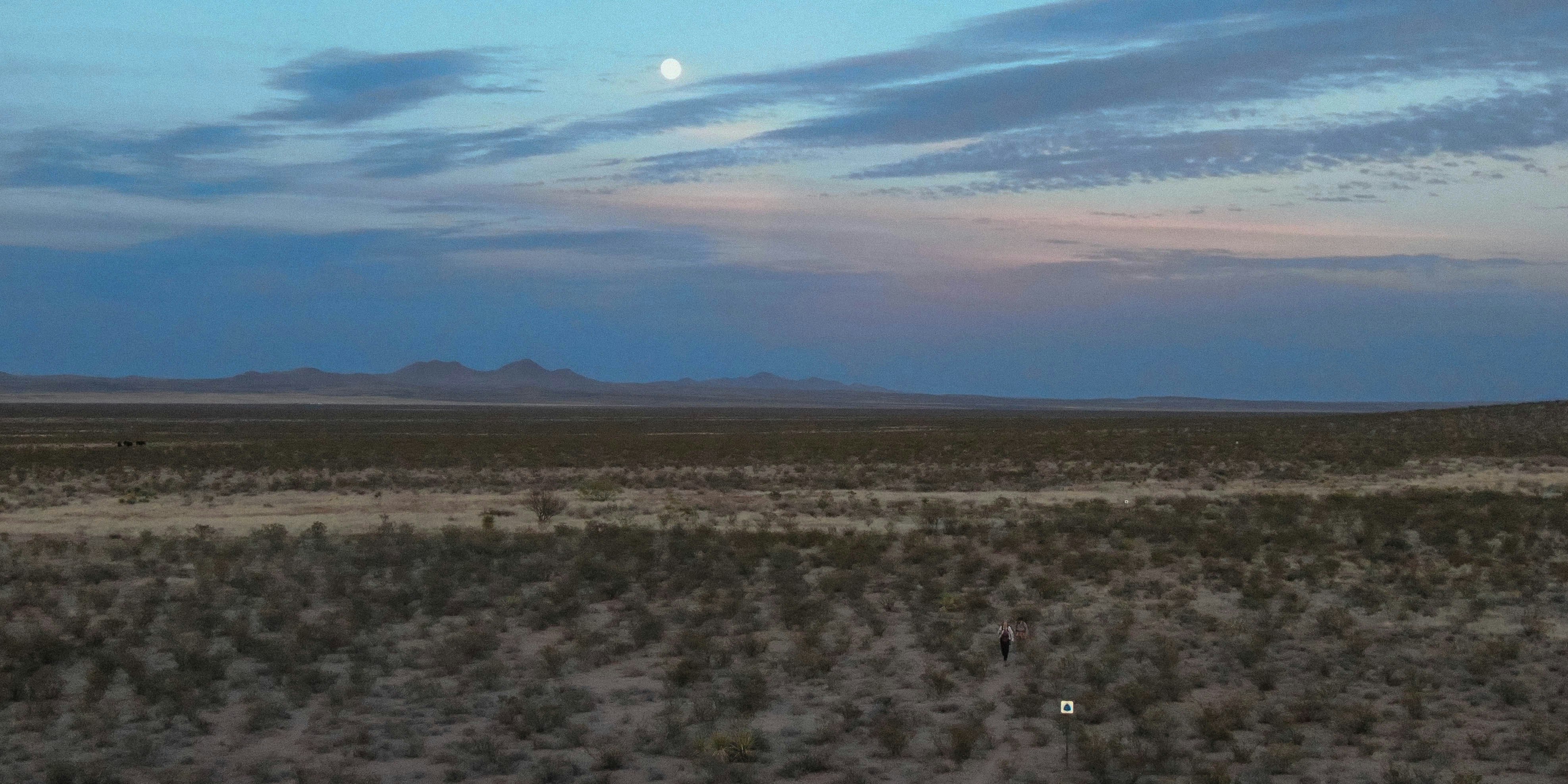 Drone shot of a hiker in an open desert section of the Continental Divide Trail.