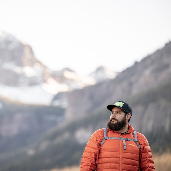 Hiker wearing an Oboz Footwear hat enjoying the view in Hyalite Canyon.