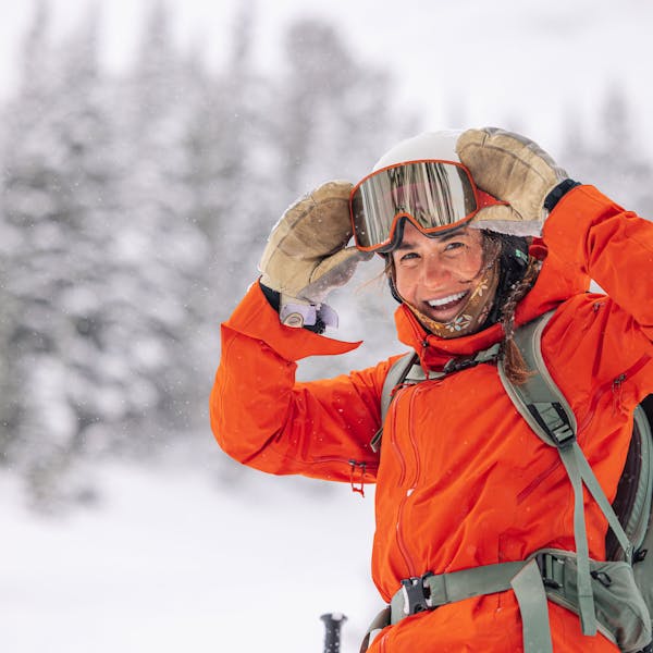 A woman in the Montana backcountry wearing the Oboz and Skida collab buff