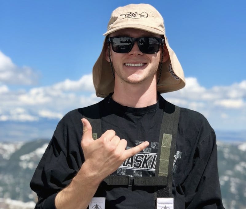 Pete Duncan swaggin at the top of a mountain