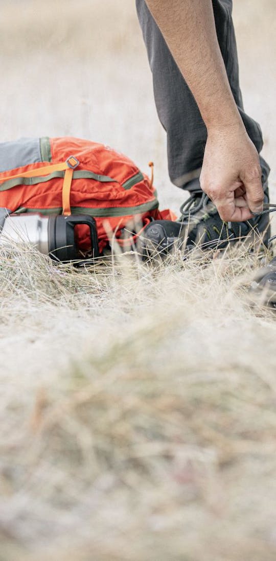 Oboz Sawtooth shoe being tied while on a hiking trip.