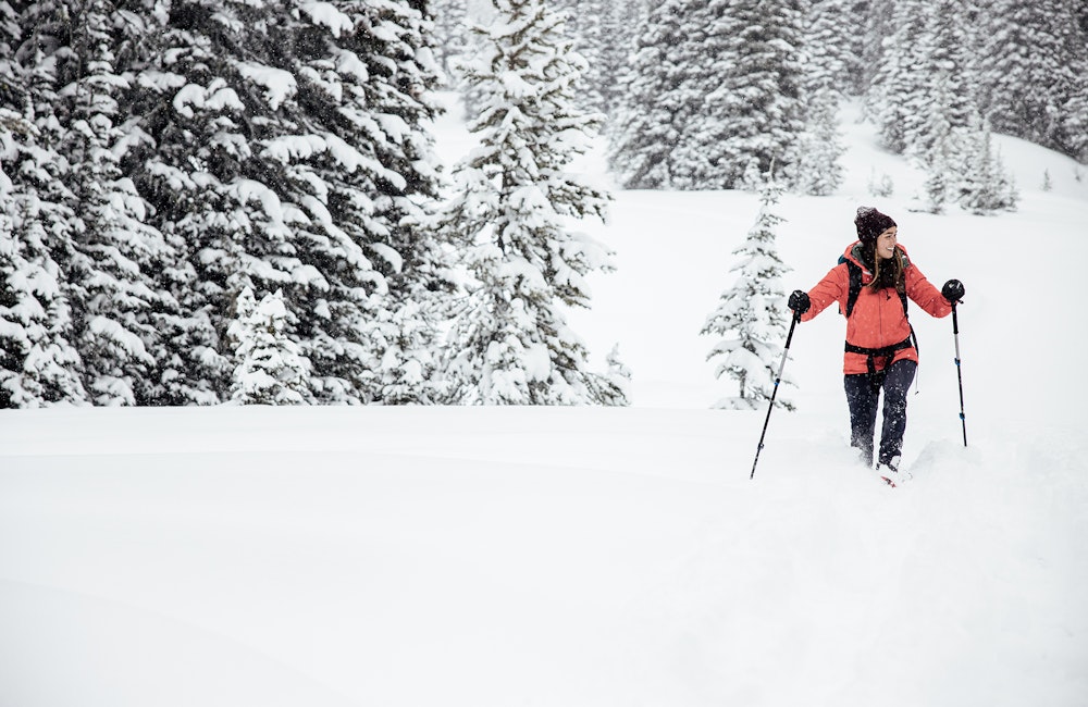 Woman walking through deep snow in Oboz winter boots.