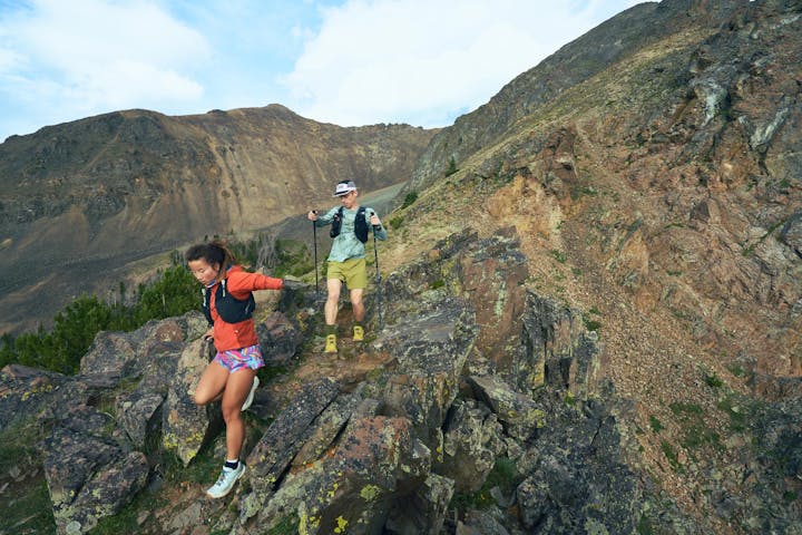 Two hikers descending a rocky ridgeline in the Oboz Katabatic Winds.