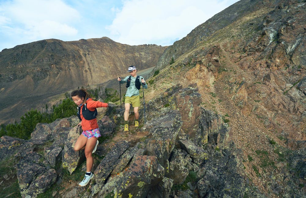 Two hikers descending a rocky ridgeline in the Oboz Katabatic Winds.