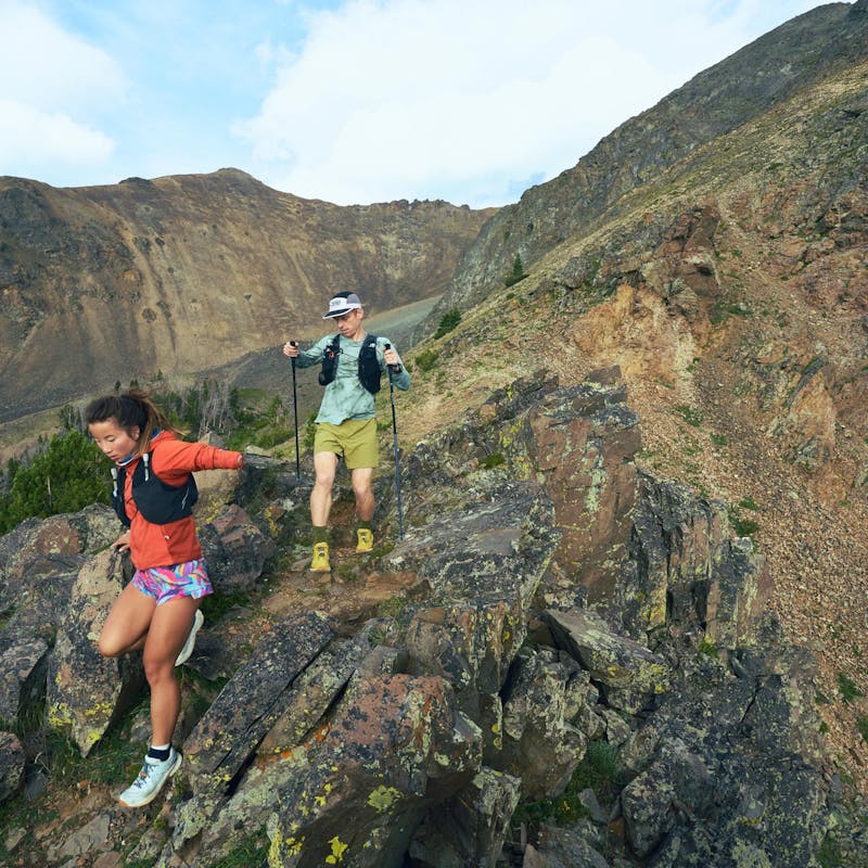 Two hikers descending a rocky ridgeline in the Oboz Katabatic Winds.