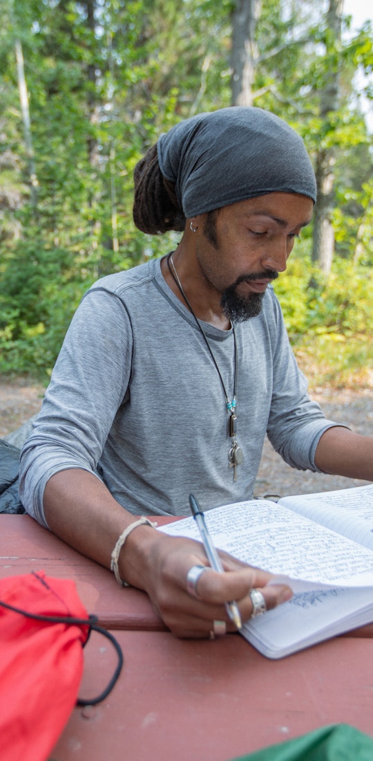 Derick Lugo journaling during his thru hike of the Appalachian Trail.