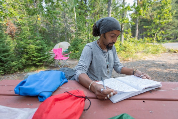 Derick Lugo journaling during his thru hike of the Appalachian Trail.