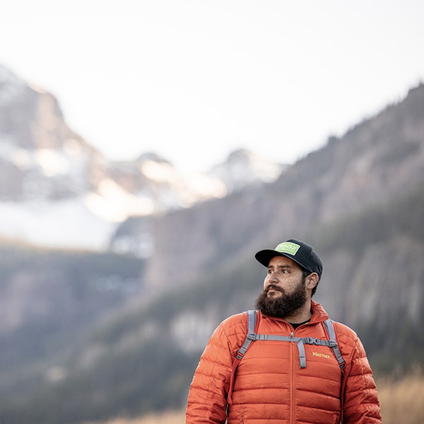 Man admiring a view of the mountains while hiking in an Oboz Footwear hat.