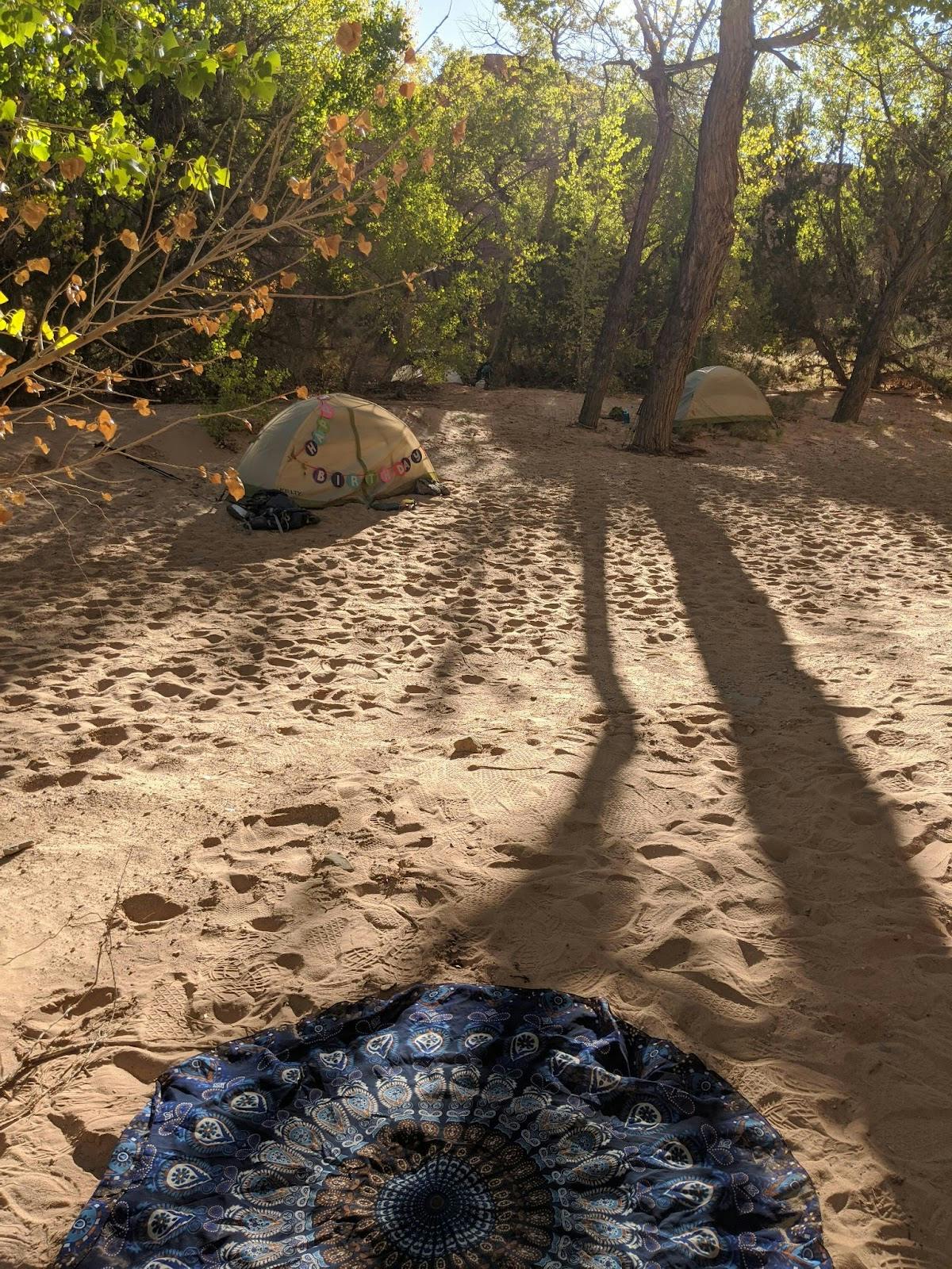 Sandy river bank tent camping along the trail viewing the surrounding scenery 