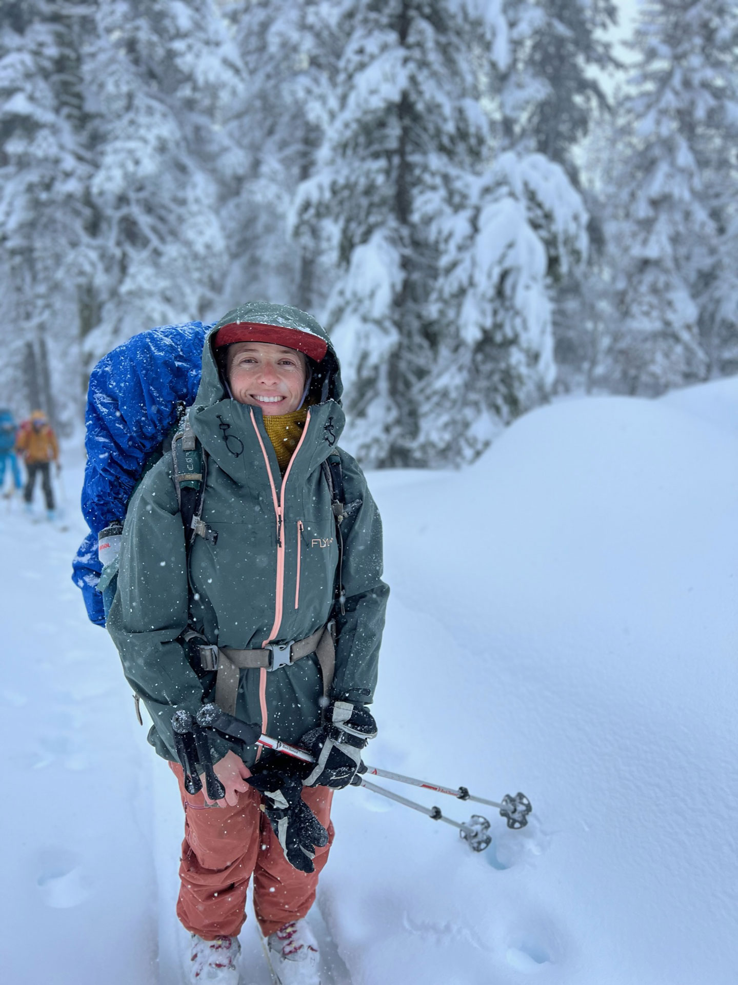 Oboz Trailblazer Ayla Mae Wild smiling on a snowy trail.