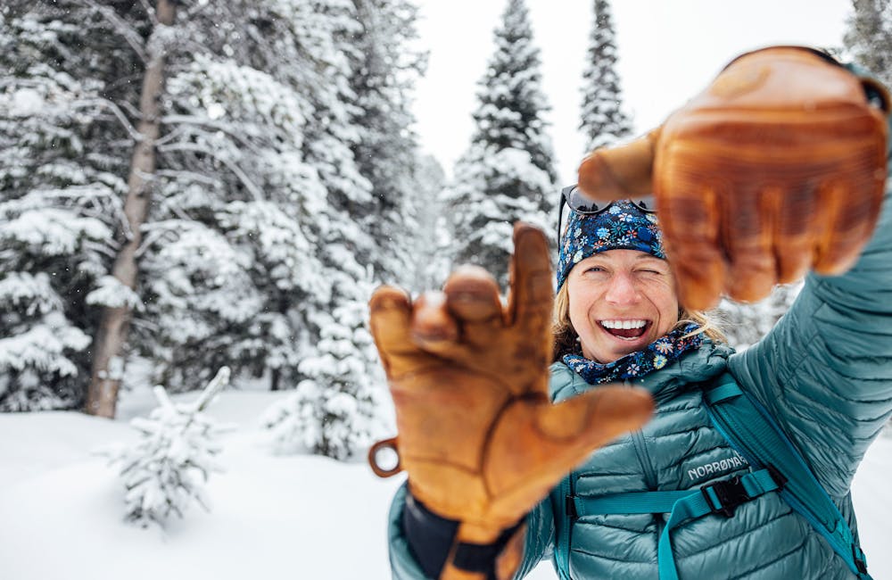 Corinne Prevot wearing the Oboz and Skida collab buff and hat in the snow.