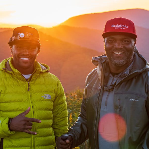 Earl Hunter of BFCT smiling in the backcountry with another hiker.