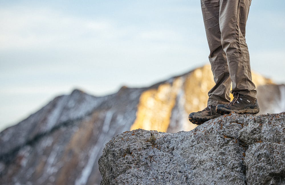 Men's Oboz Bridger Mid waterproof perched on a rock.