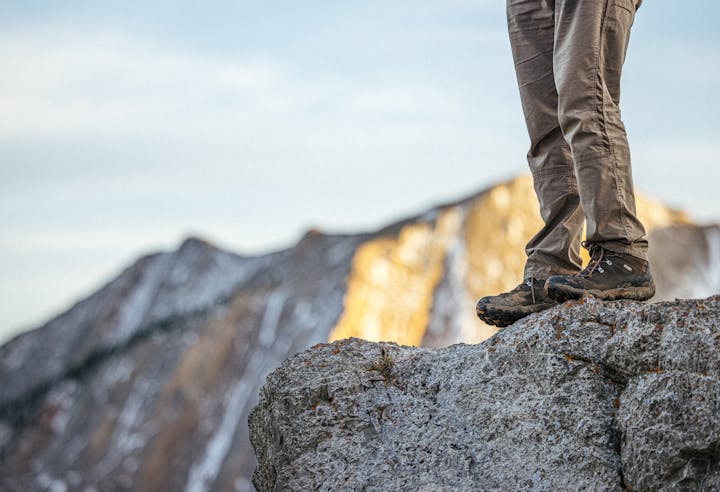 Hiker on a rock outcropping in Oboz Bridger mid hiking boots.