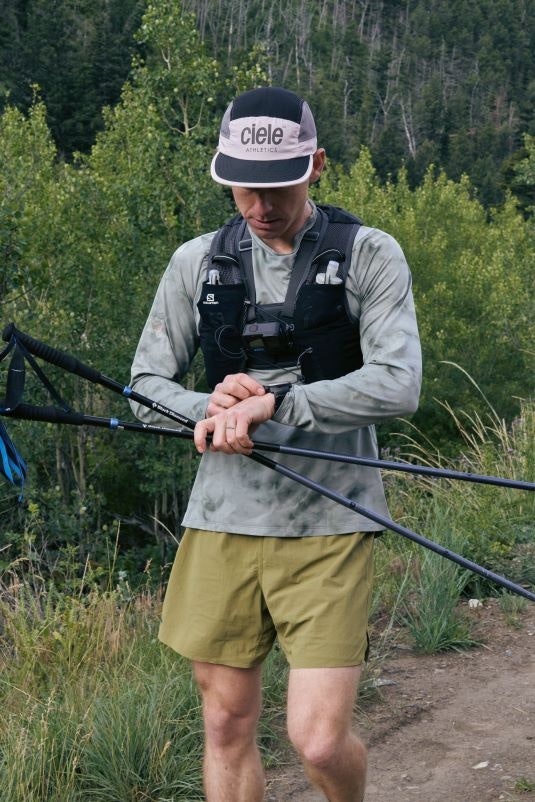 Otto Stephan checks his watch on a trail run through Montana trails. 