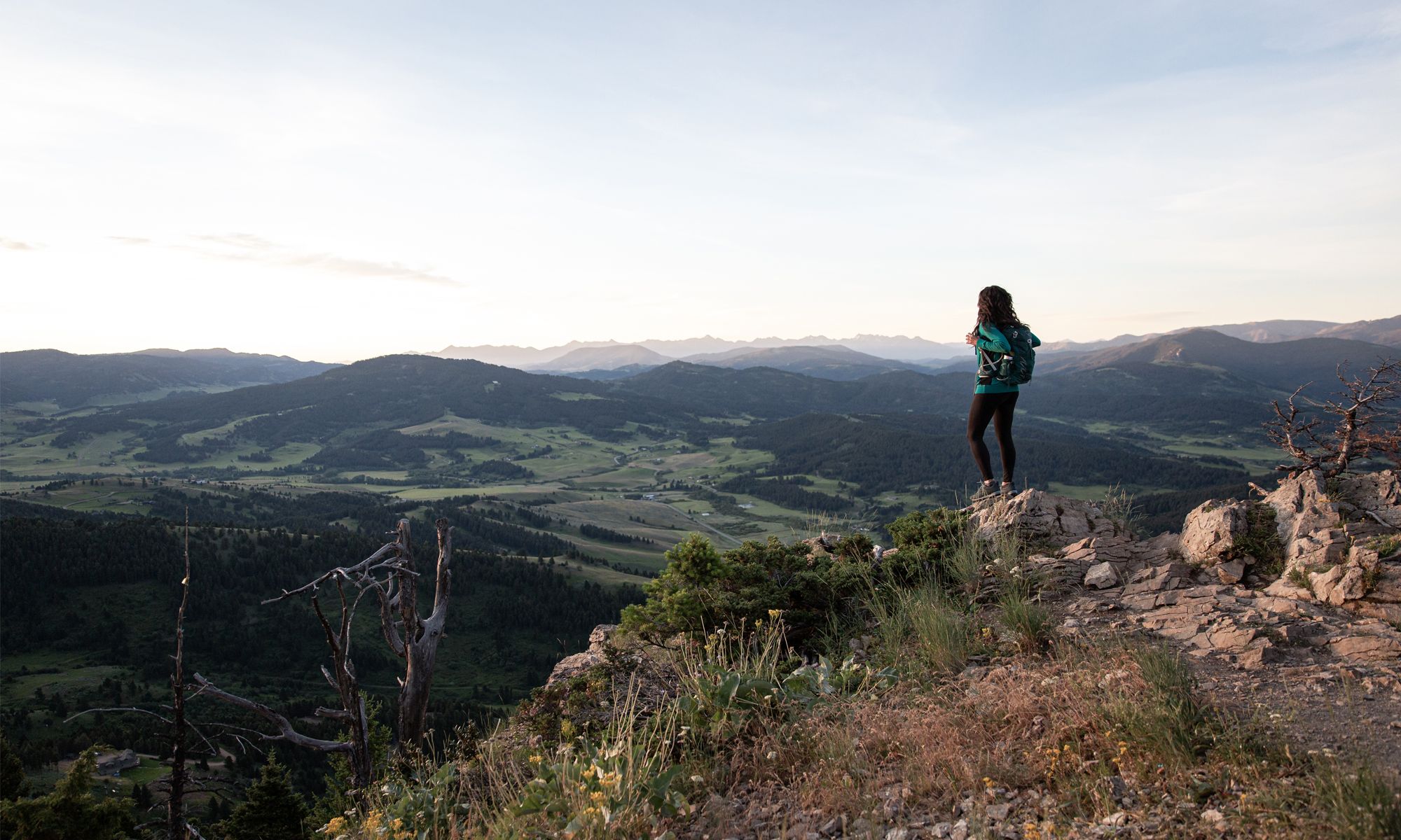 Jackie Nourse overlooking mountain ranges in Oboz hiking boots.