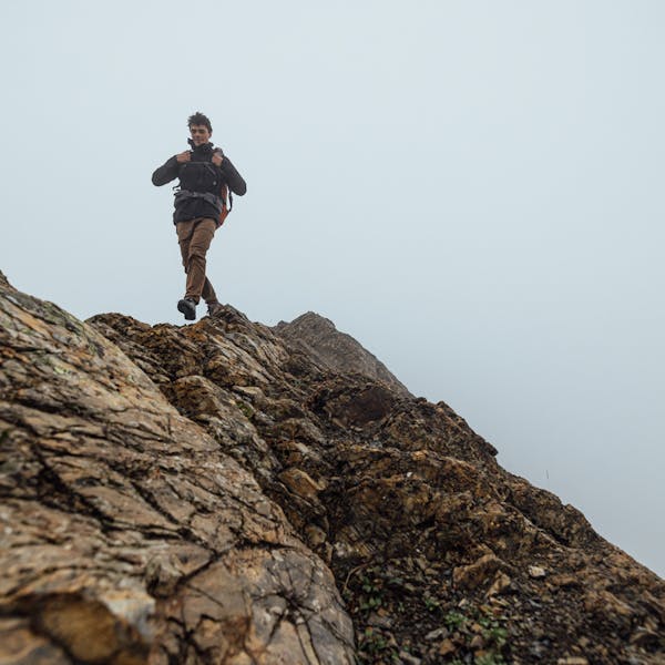 Hiker trekking up a rocky slope in the Sawtooth X hiking boot.