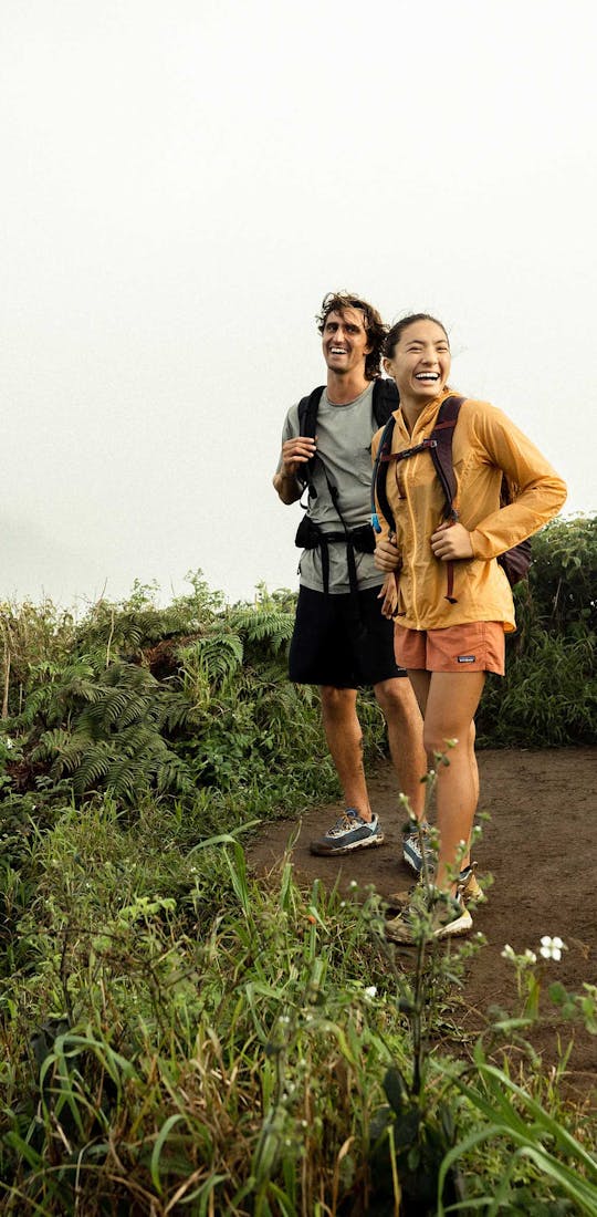 The Oboz Katabatic Mid Waterproof hiking boot on a grassy mountainside in Switzerland.