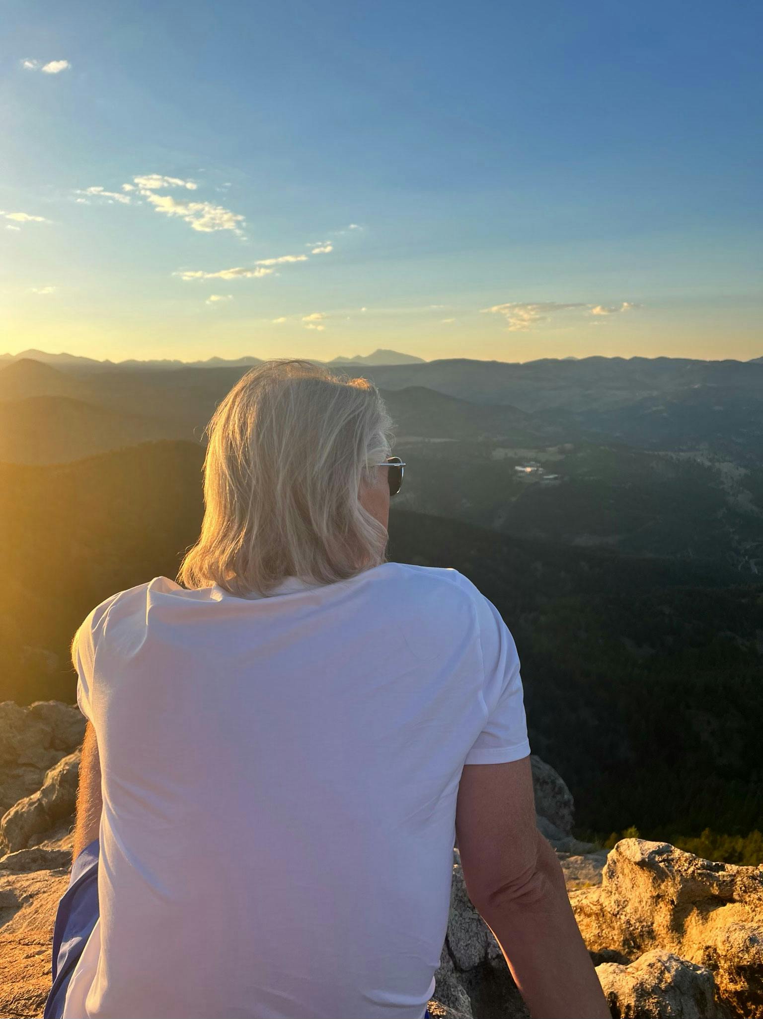 Oboz trailblazer Buddy Teaster admiring a view at sunset.