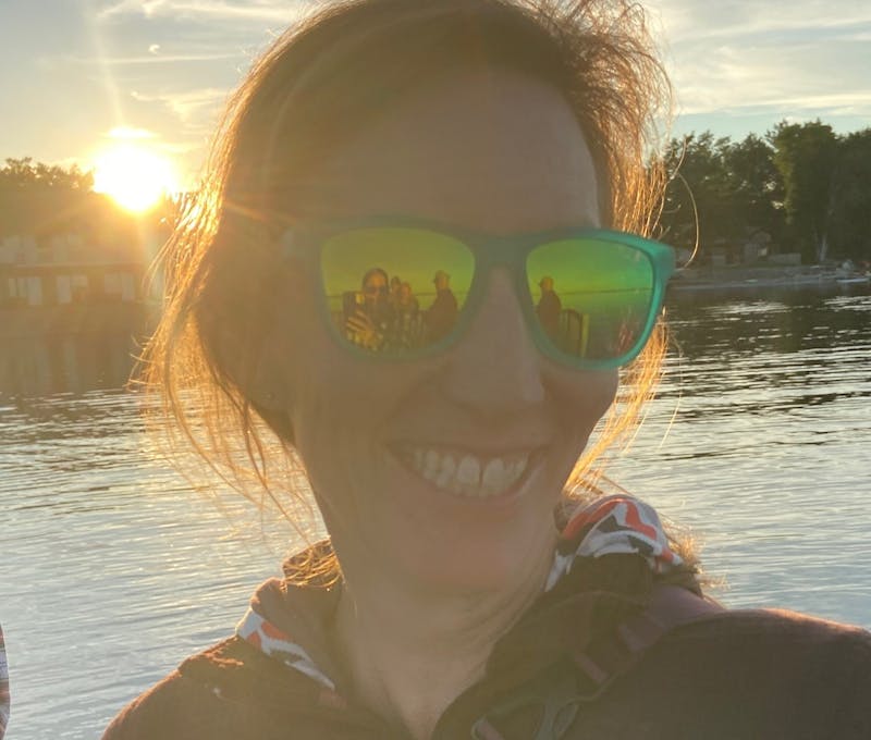 Liz Uhl on a dock enjoying some time by a lake.