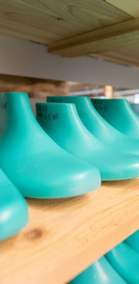 A group of lasts on a shelf used as the basis for all Oboz shoe designs.