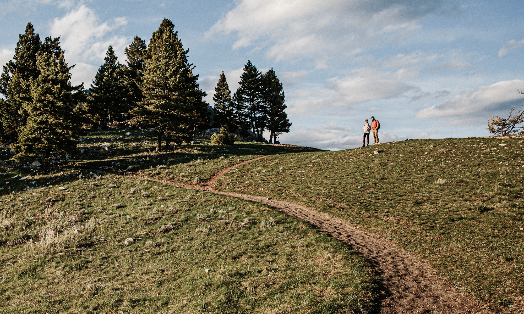 Two people hiking a trail near Bozeman, MT.