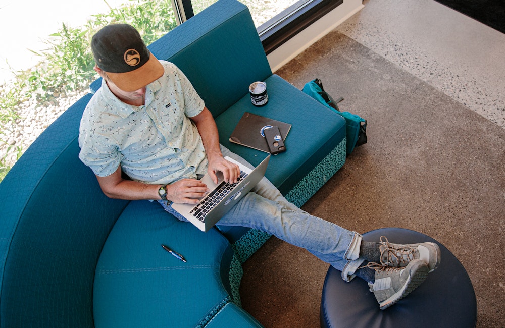 Man working in an office space wearing Oboz Bozeman Low shoes.