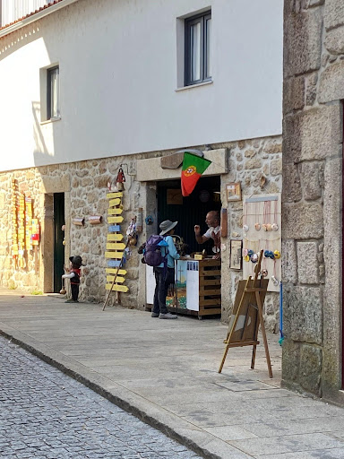 A backpacker stops along a thru hike of the Camino de Santiago to meet a vendor. 