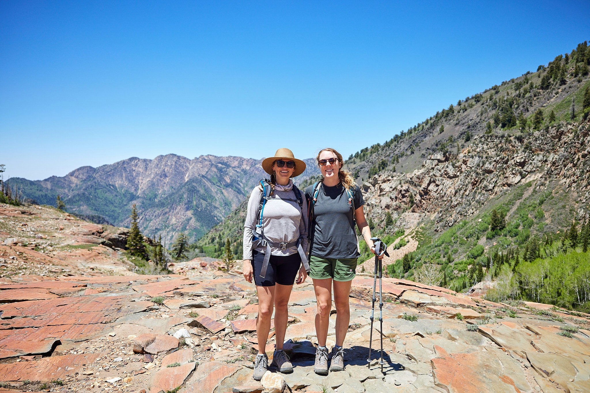 Two woman smiling on a hike in their Oboz hiking shoes